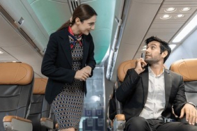 flight-attendant-interacts-male-passenger-260nw-2638111347~2