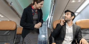 flight-attendant-interacts-male-passenger-260nw-2638111347~2