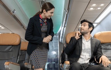 flight-attendant-interacts-male-passenger-260nw-2638111347~2